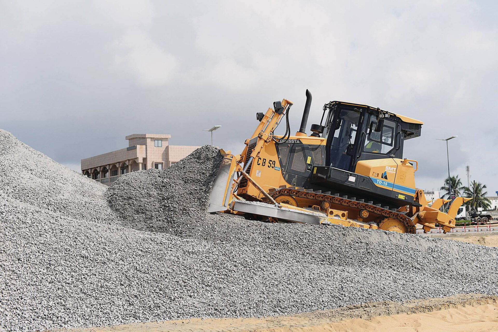 Powerful Dressta crawler dozer working on a large aggregate stockpile, demonstrating its superior pushing power for site management