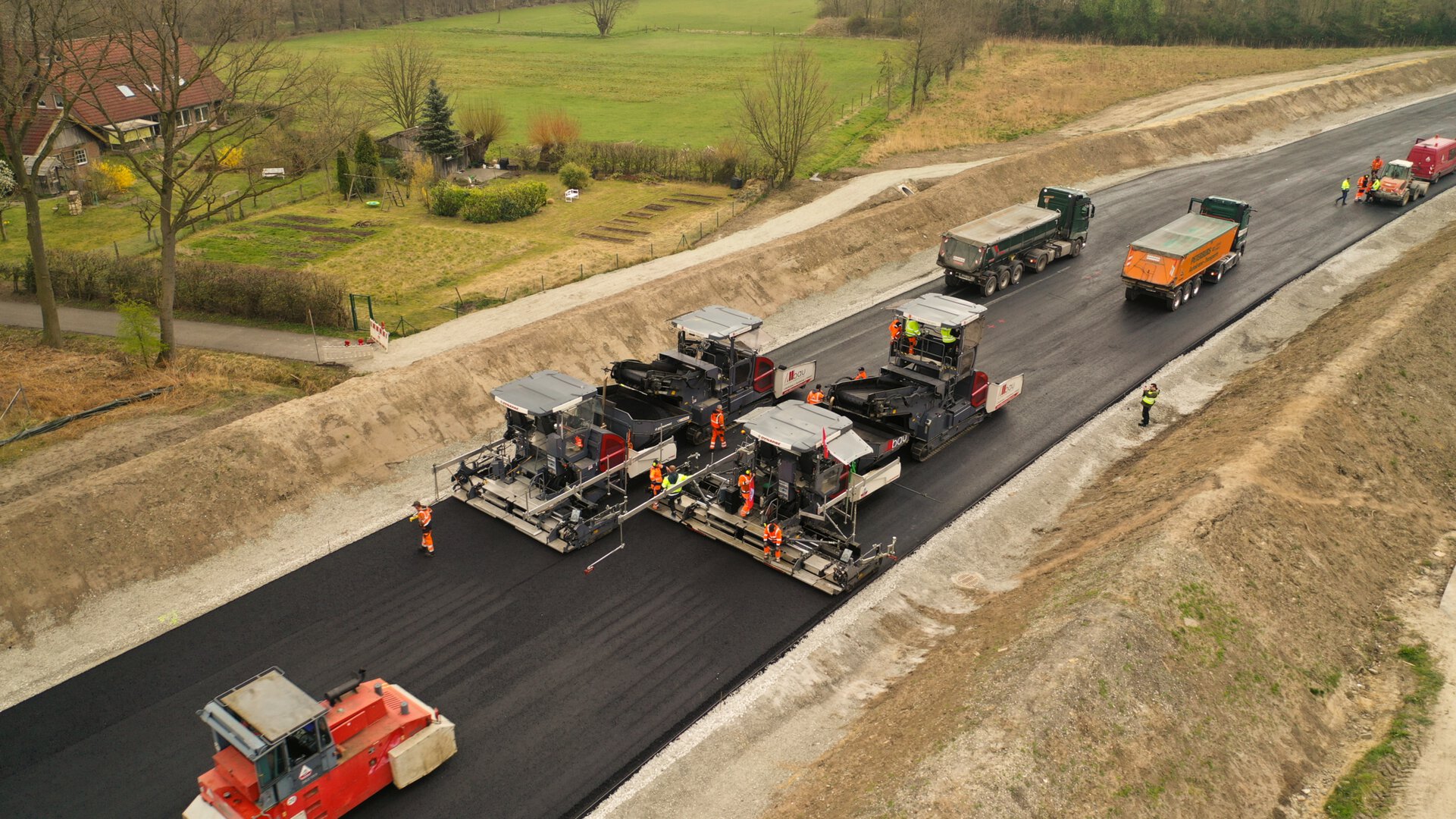 Dynapac paving train, integrating mobile feeders and asphalt pavers for non-stop road construction and superior mat quality.