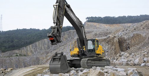 Expert SMT technician inspecting excavator undercarriage wear parts to optimize performance and protect your machinery investment in the field.